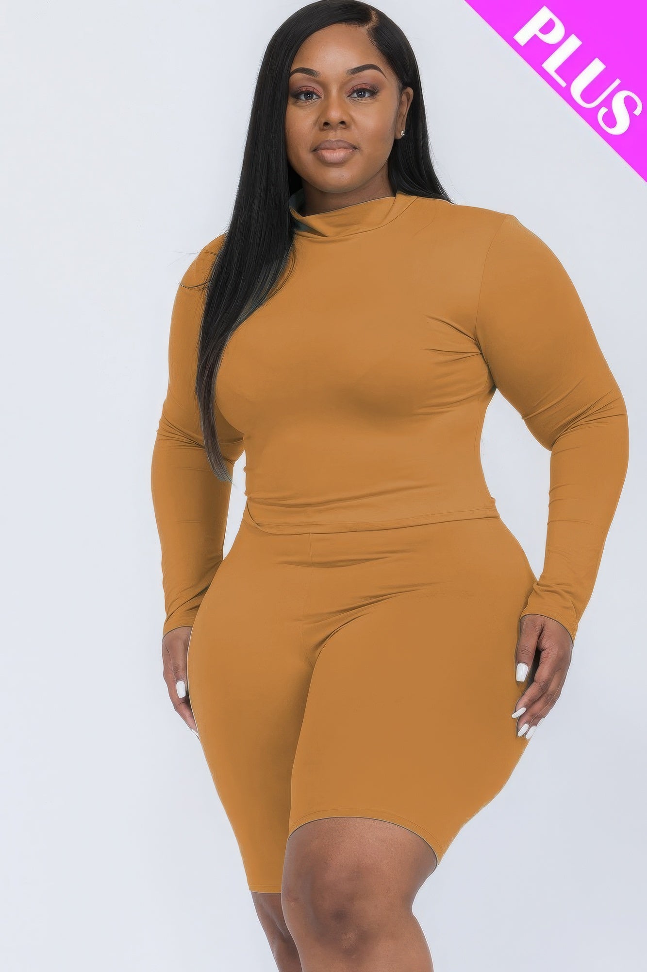 Plus-size woman wearing a brown mock neck top and biker shorts set, showcasing a stylish and comfortable ensemble for curves.