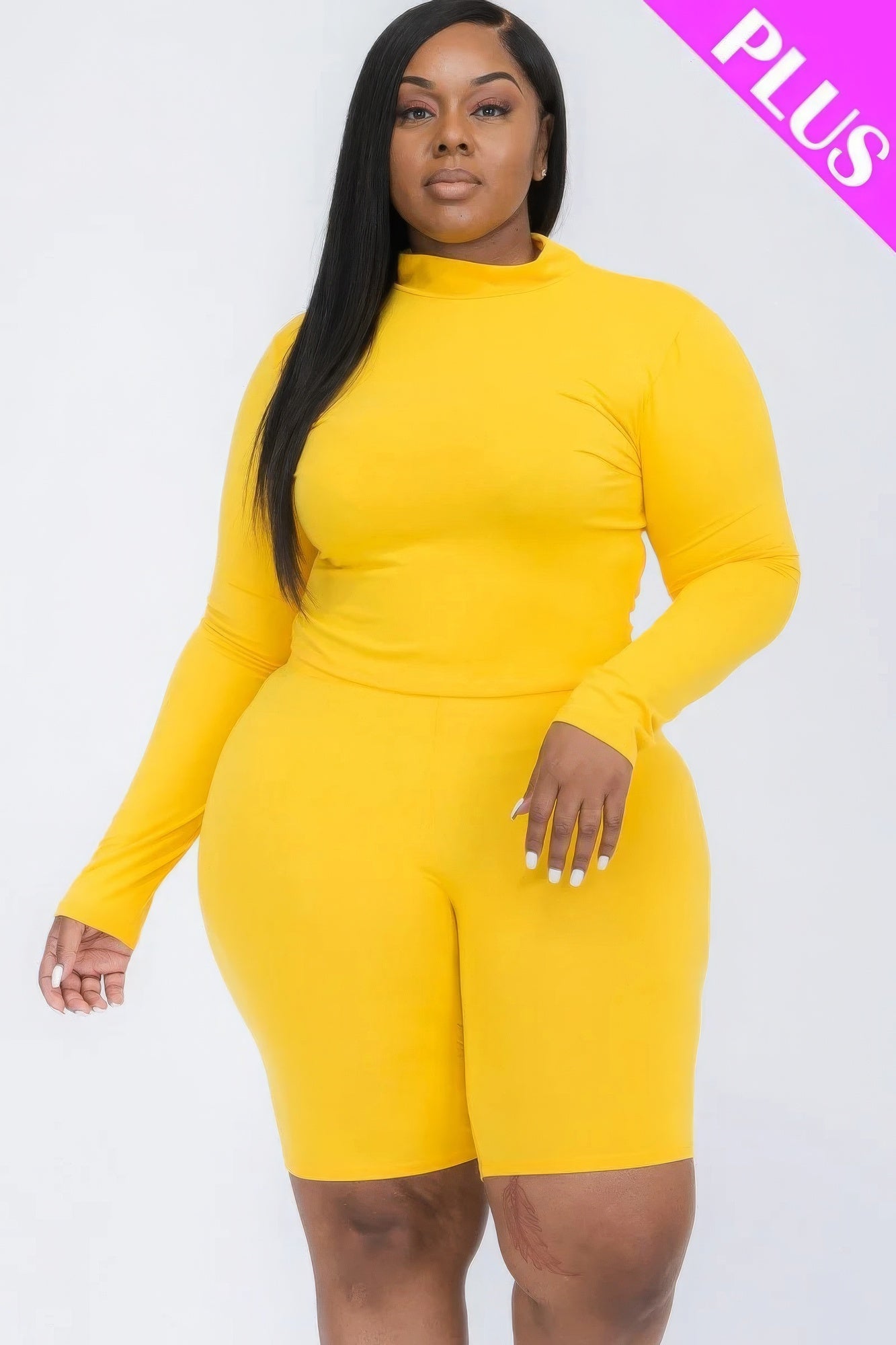 Plus size mock neck top and biker shorts set in bright yellow, showcasing stylish and comfortable fashion for curvy women.