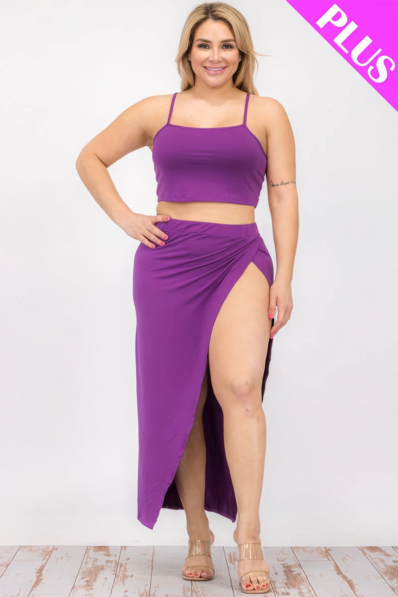 Plus size purple crop cami and split thigh maxi skirt set on a smiling model