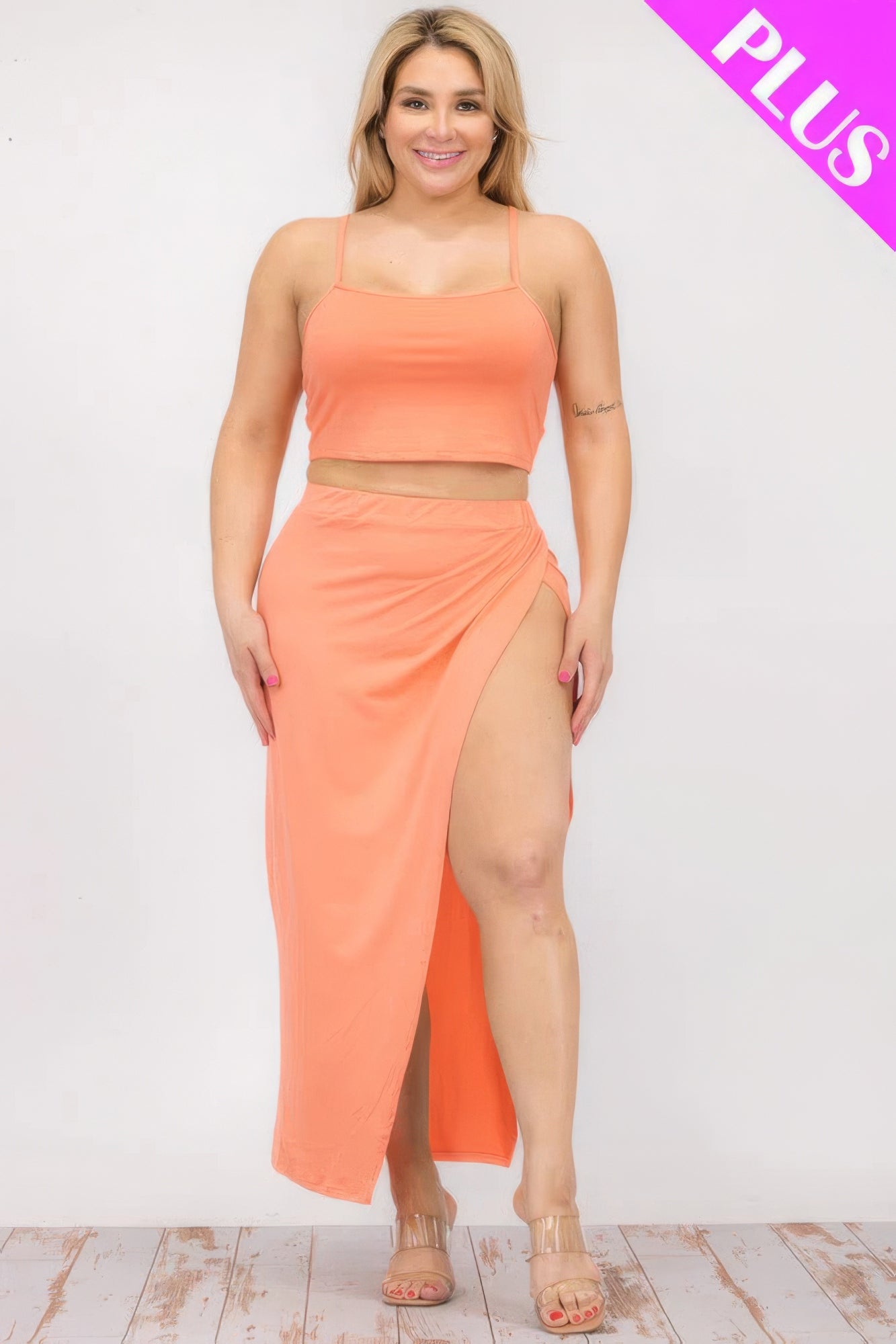 Plus size orange crop cami and split thigh maxi skirt set on model, showcasing stylish and comfortable design.