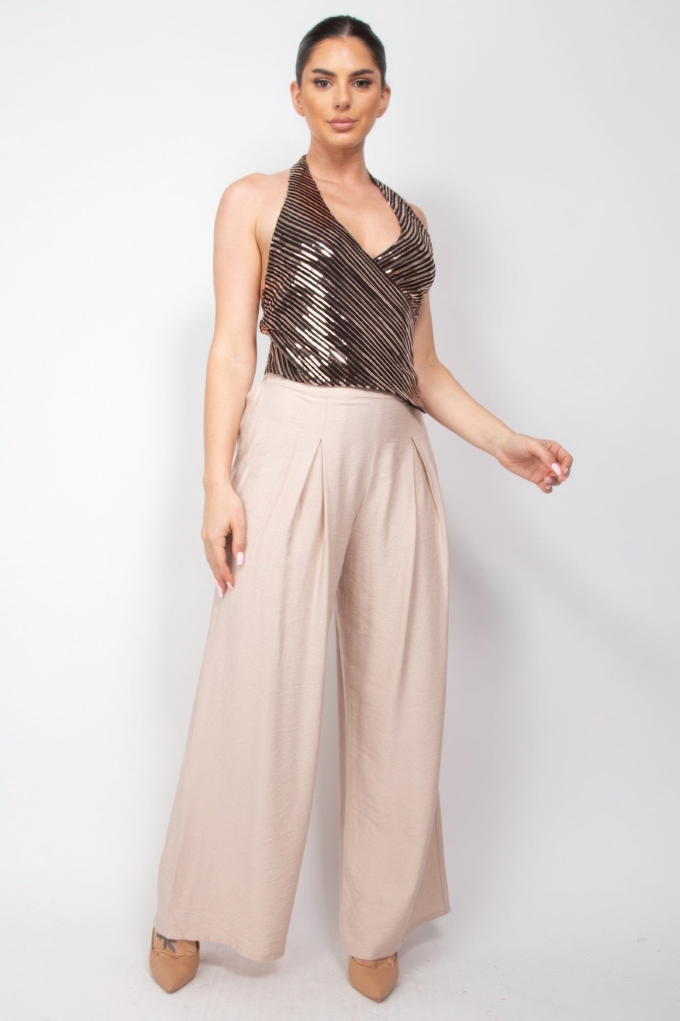 Woman wearing Surplice Halter Sequin Top and wide-leg pants, Love It Clothing fashion, modern elegance and glamour.