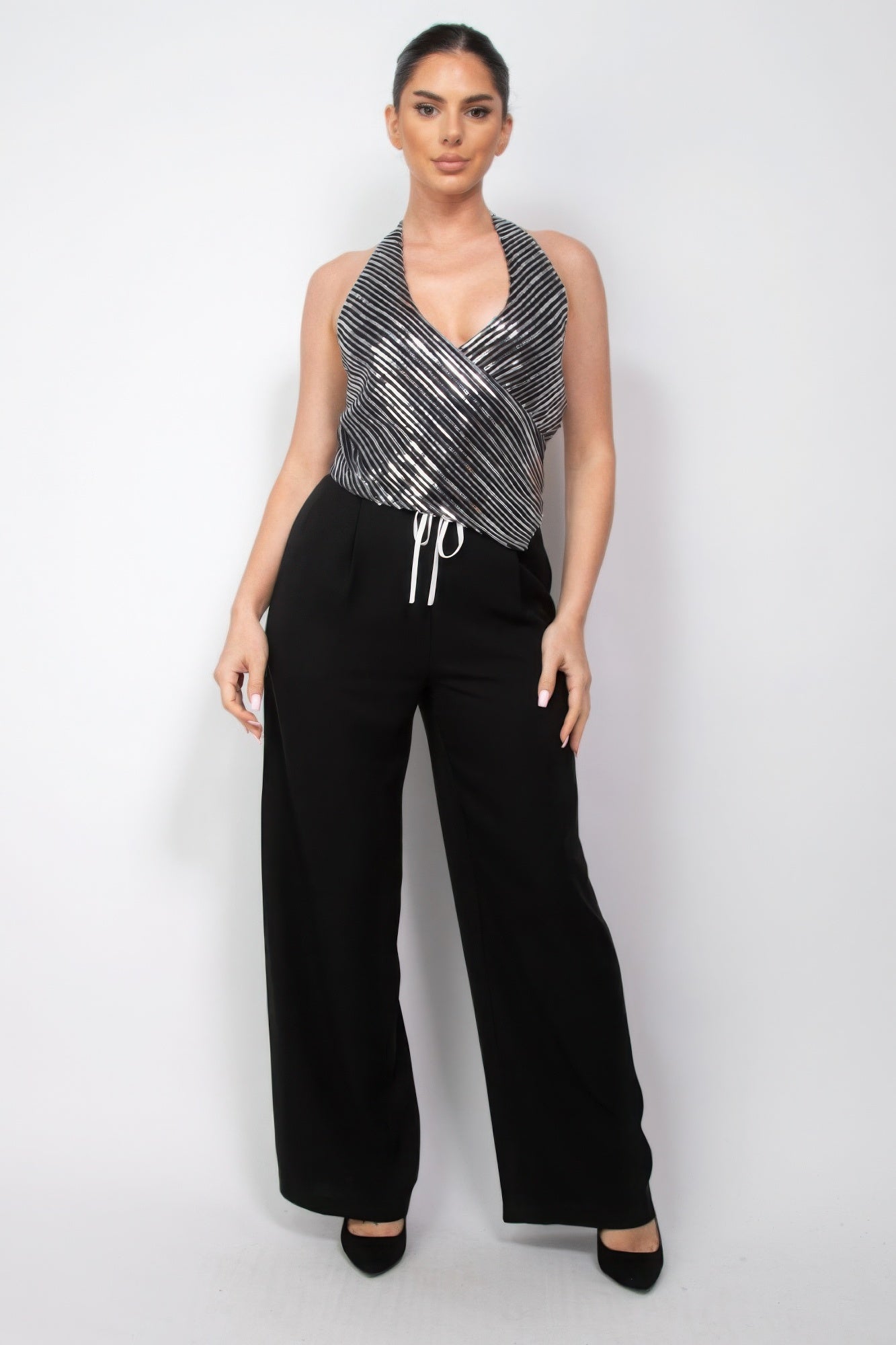 Woman wearing Surplice Halter Sequin Top from Love It Clothing, showcasing modern glamour and elegance for evening events.