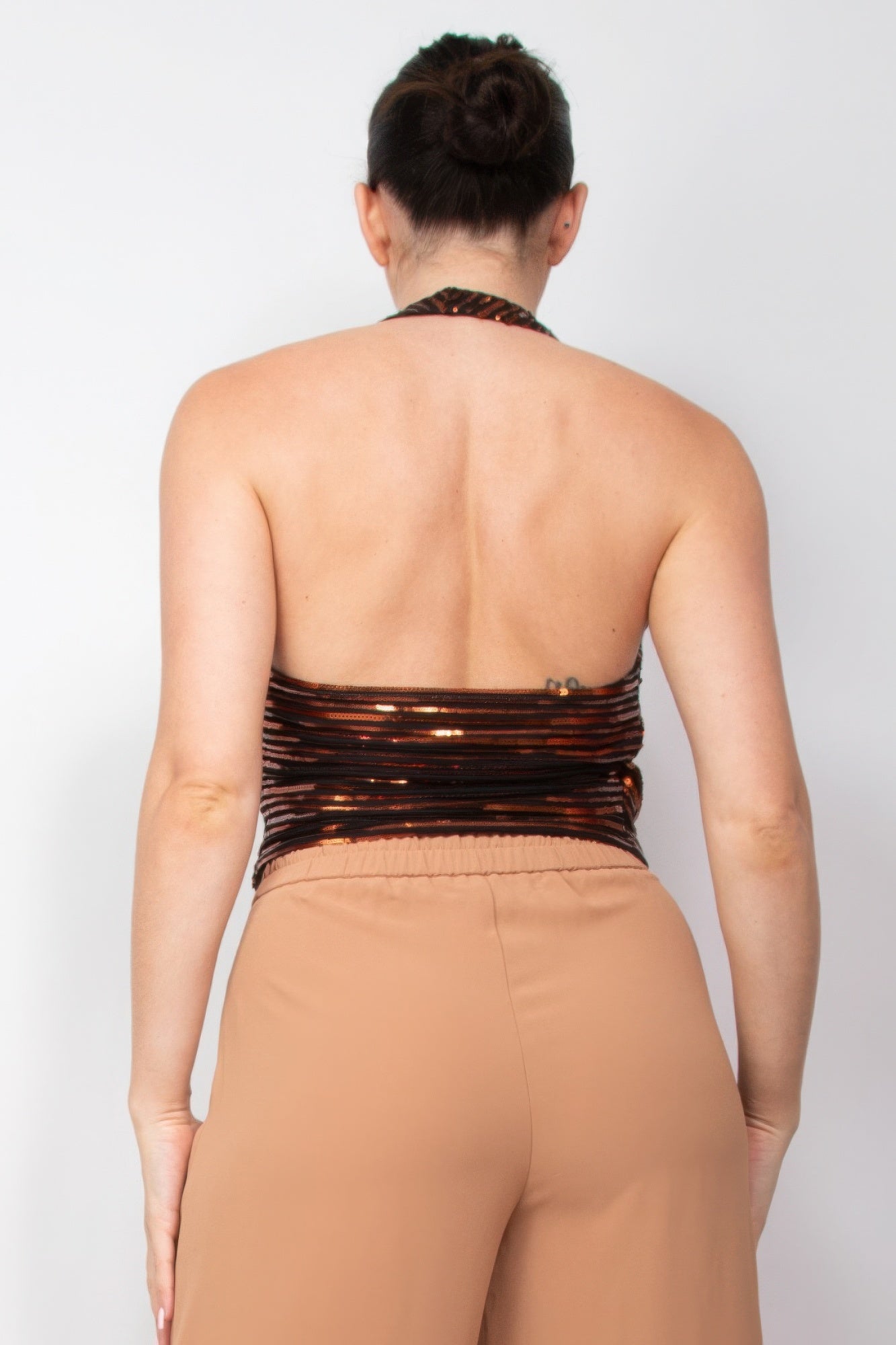 Woman wearing Surplice Halter Sequin Top by Love It Clothing, showcasing back view design, ideal for special events.