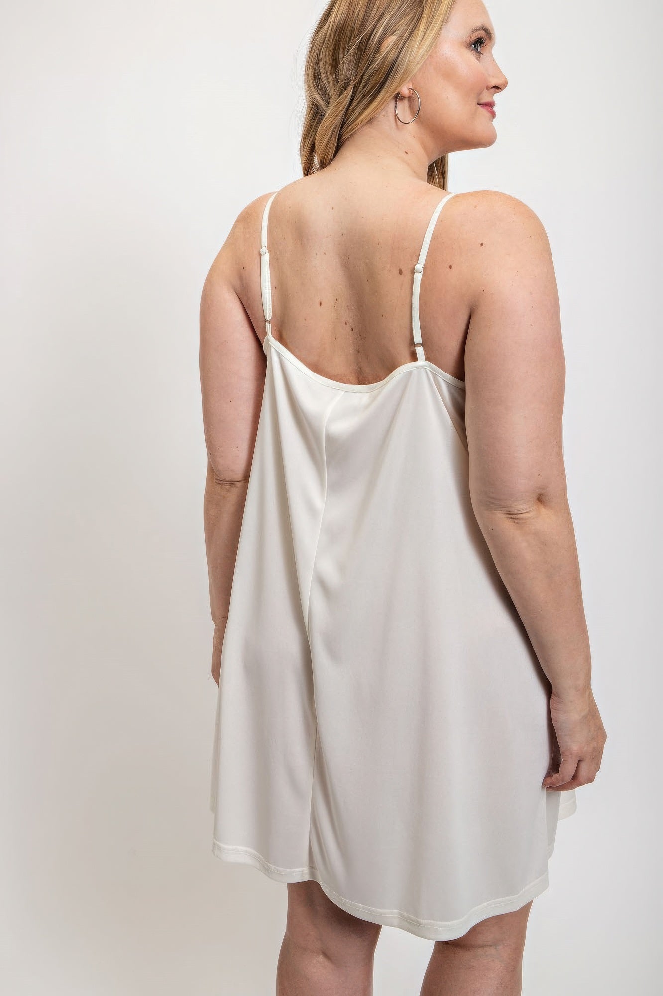 White V-neck slip dress with adjustable straps by Loveitclothing.com, showcasing back view for a comfortable and sleek fit.