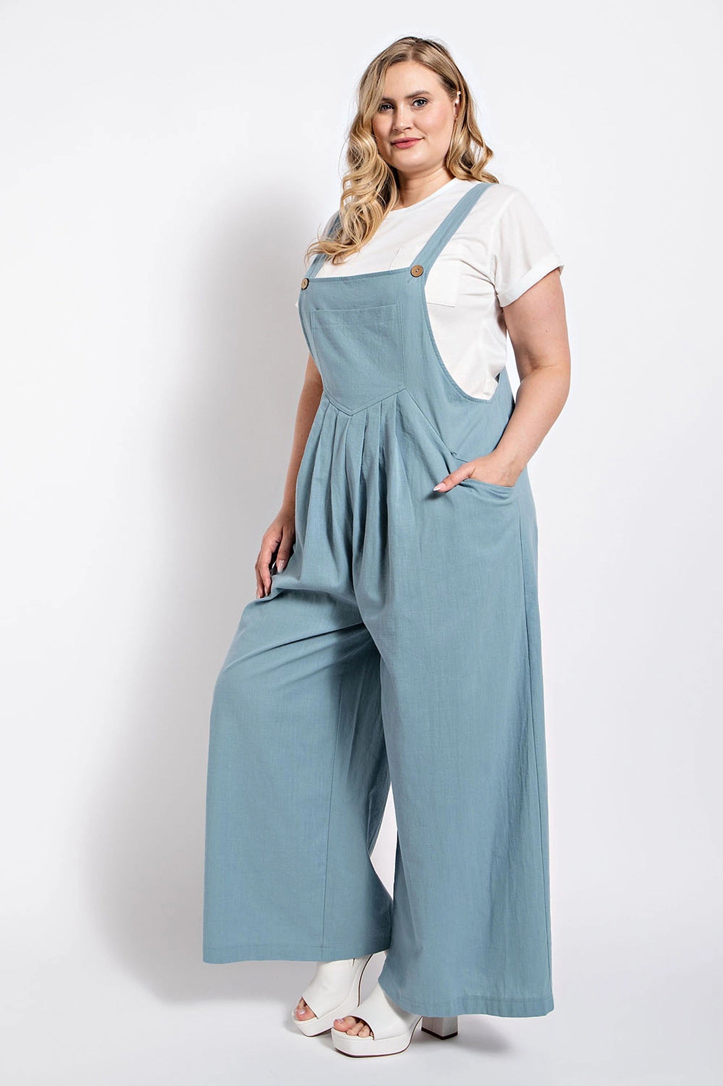 Woman wearing stone-colored pintuck detail overall with side pockets from Loveitclothing.com.