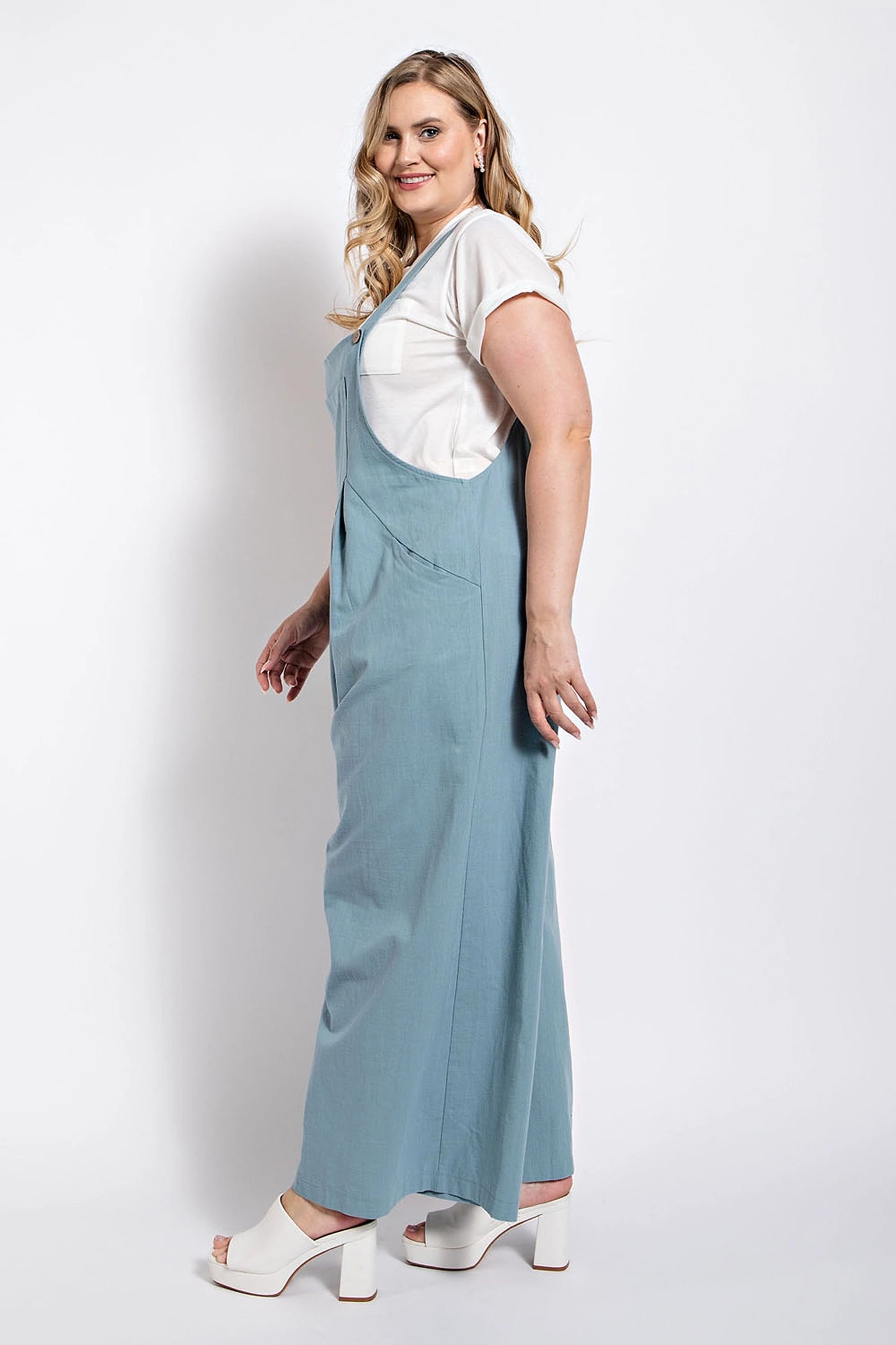 Woman wearing a blue pintuck detail overall with side pockets, styled with a white top, Loveitclothing.com fashion.