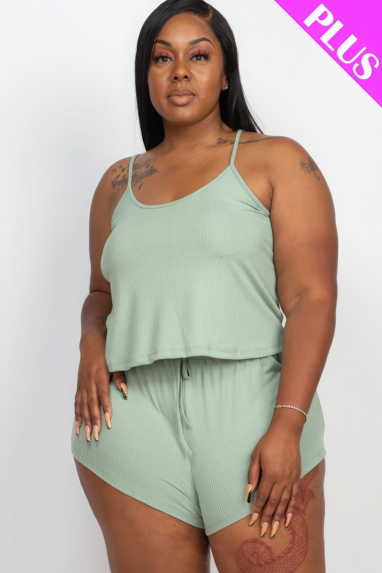 Plus size model wearing ribbed strappy top and shorts set in Cloud color, showcasing stylish and comfortable fashion ensemble.