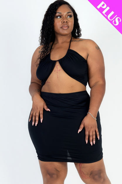 Plus size black crisscross halter top and ruched mini skirt set on model, showcasing a stylish and comfortable ensemble for sizes 1XL-3XL.