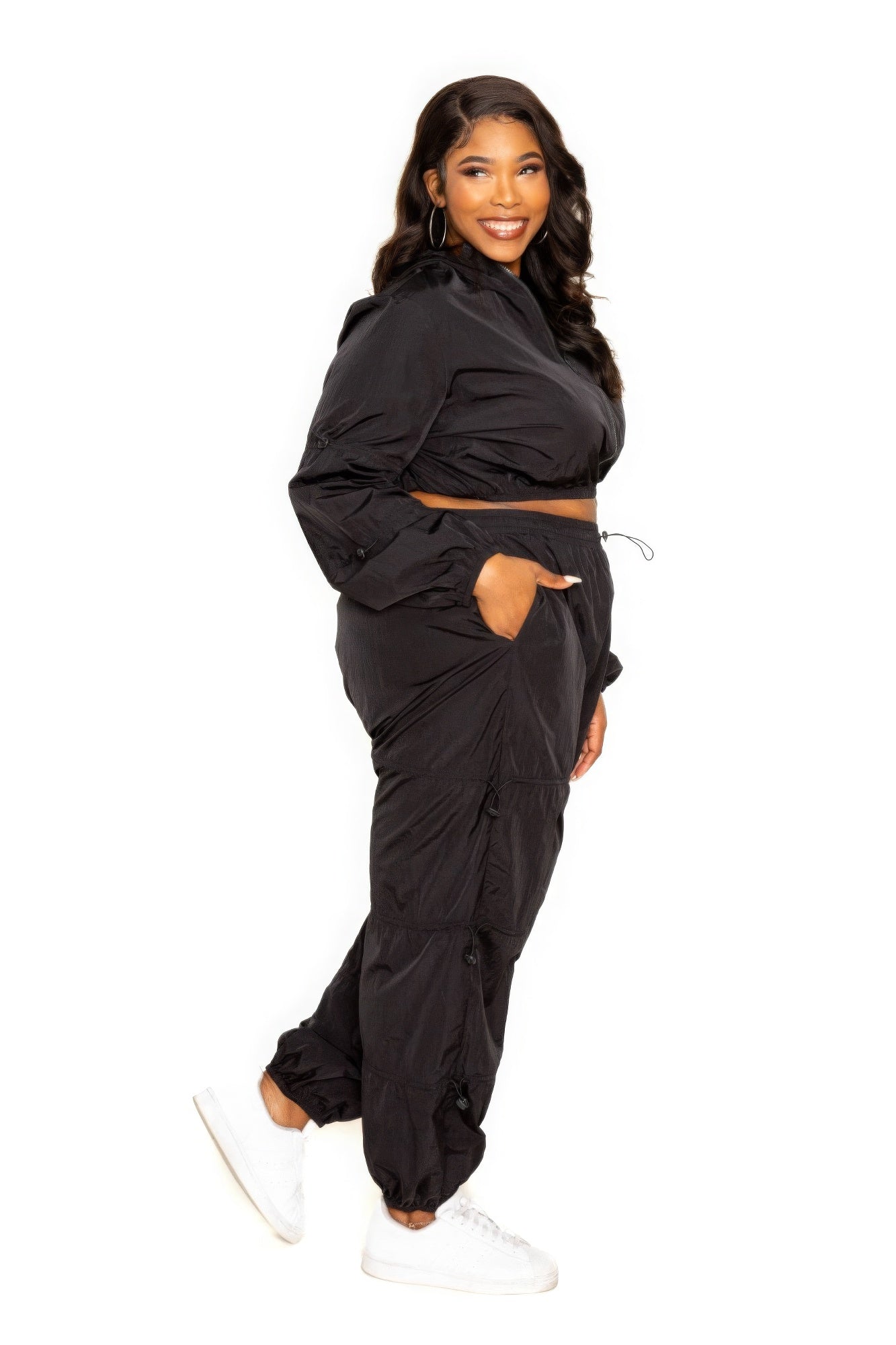 Model wearing black Active Zip Up Set with Cord Lock Detail, showcasing extended size activewear in 1XL to 3XL, side view.