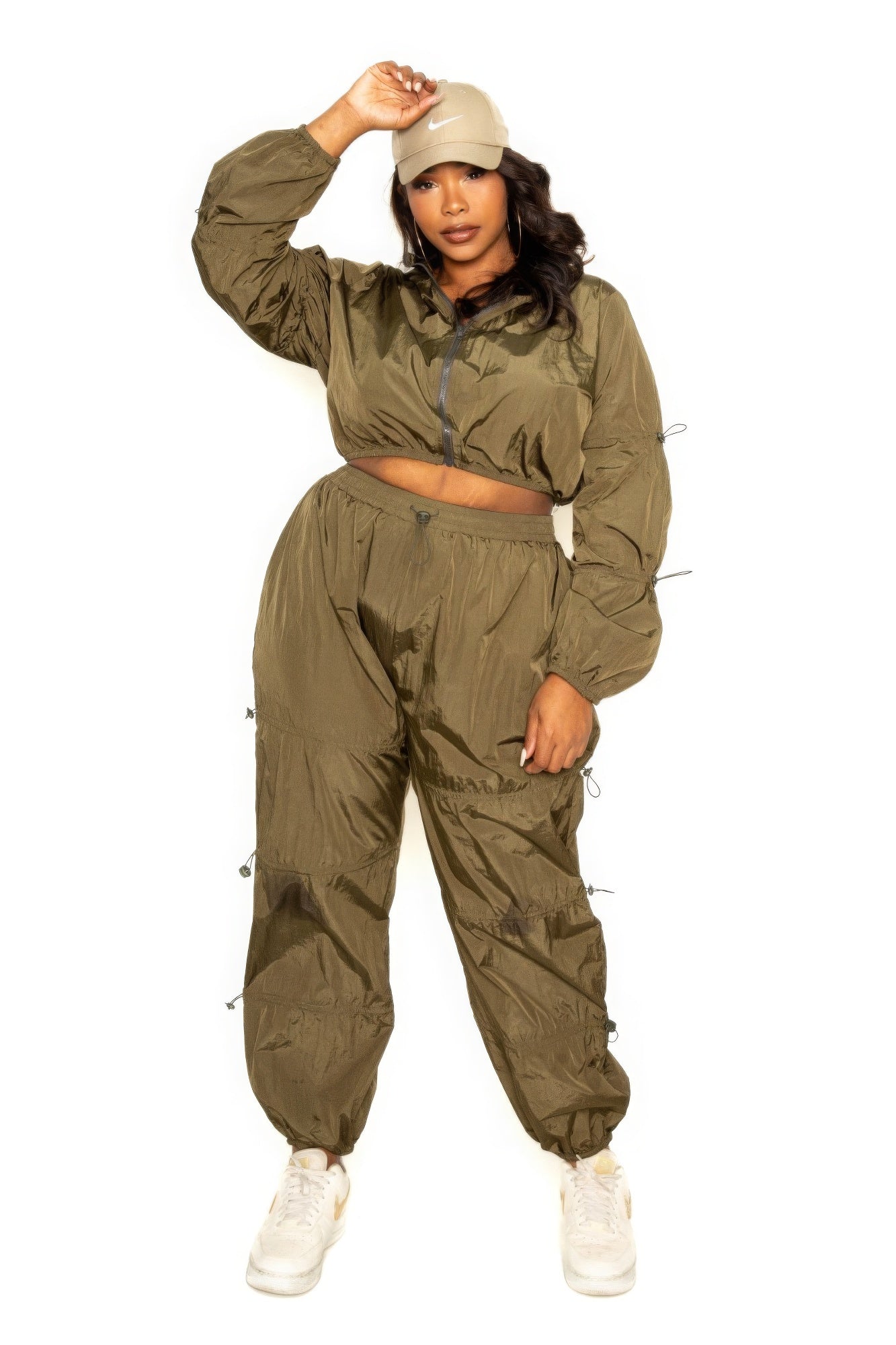 Plus size model wearing olive green active zip up set with cord lock, perfect for stylish and comfortable workouts.