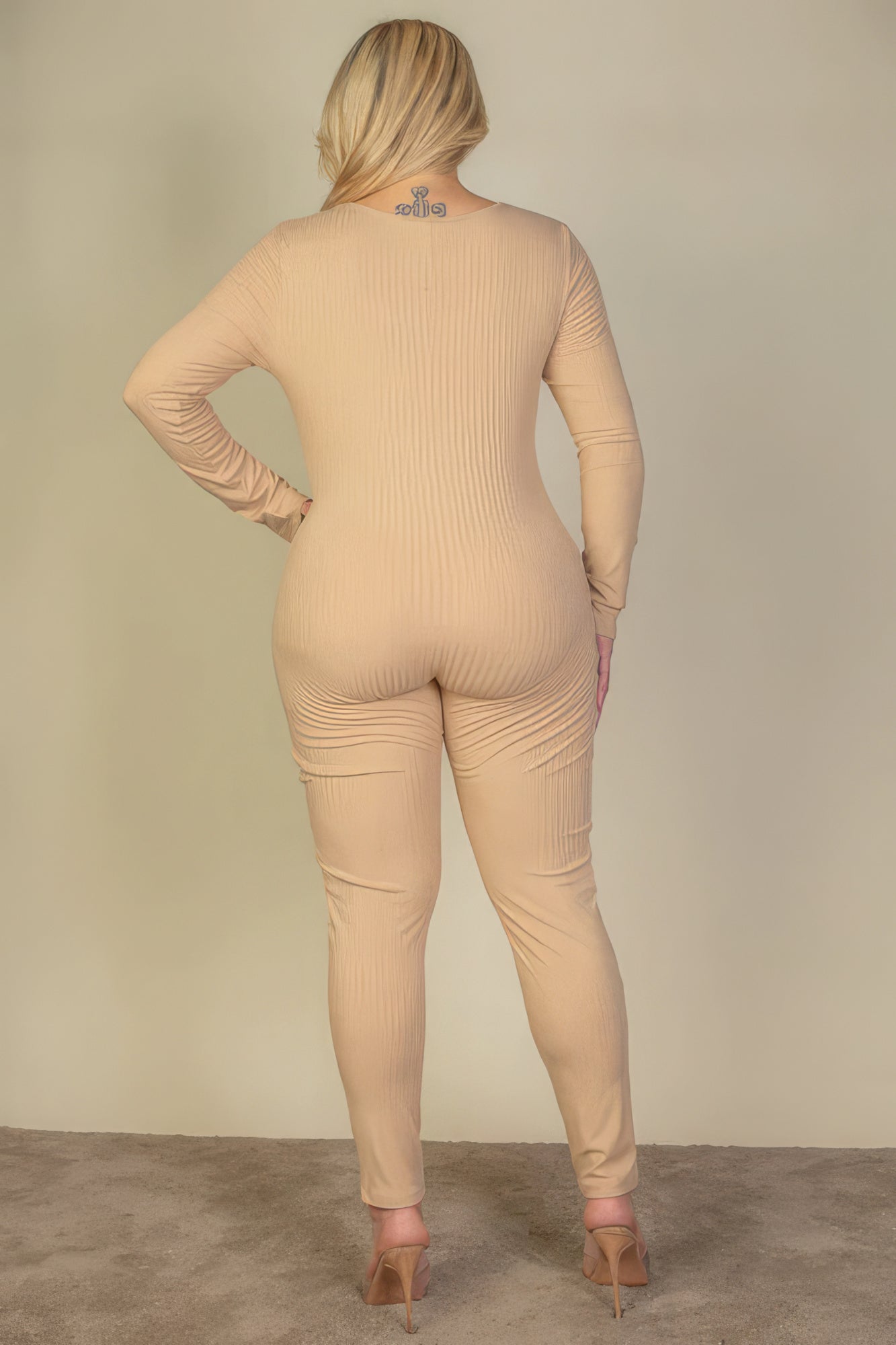 Plus size ribbed scoop neck long sleeve jumpsuit in nude color from Loveitclothing.com, back view on model.