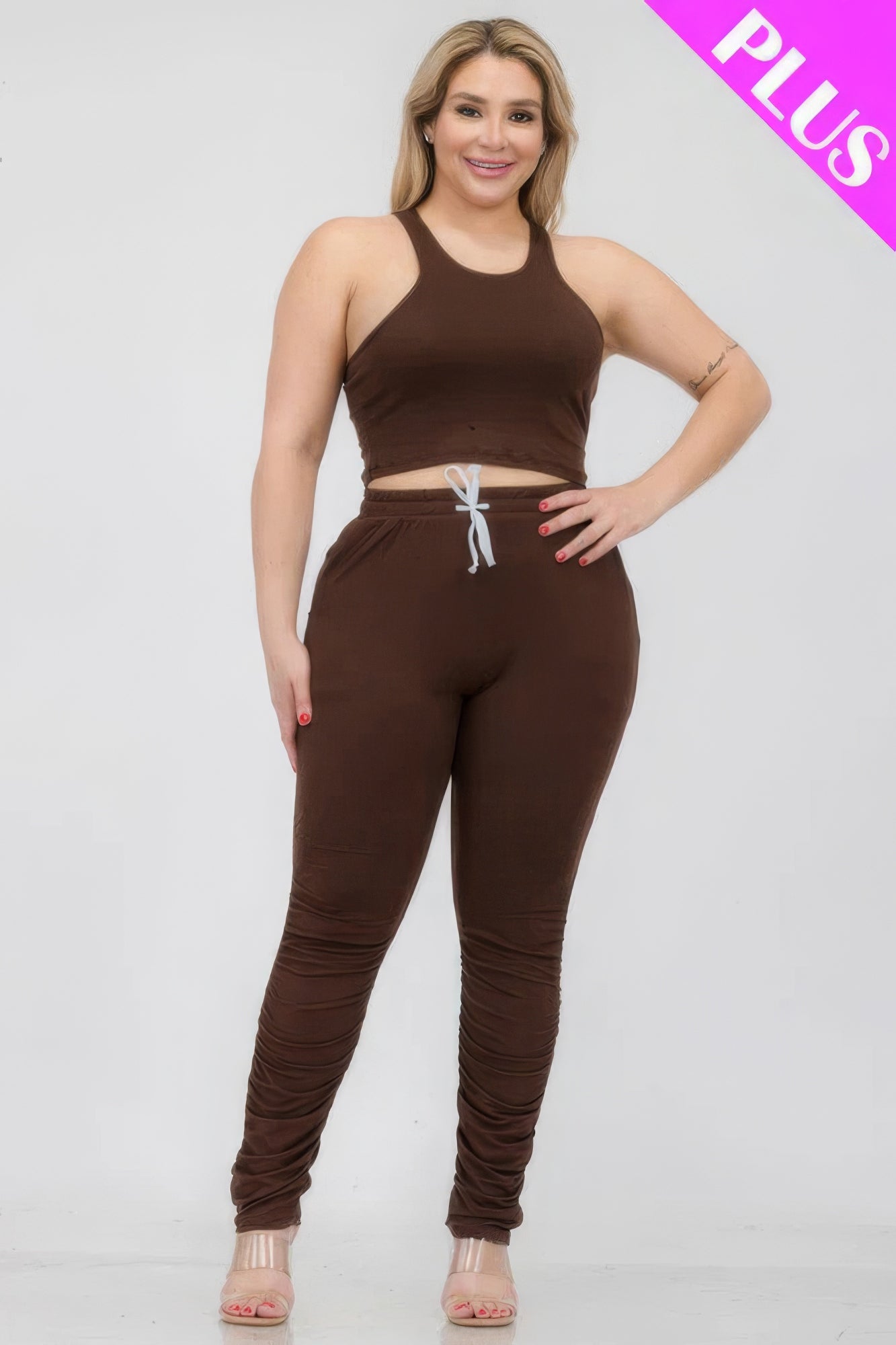 Plus size brown crop tank top and ruched pants set for women, made of polyester and spandex, offering style and comfort.