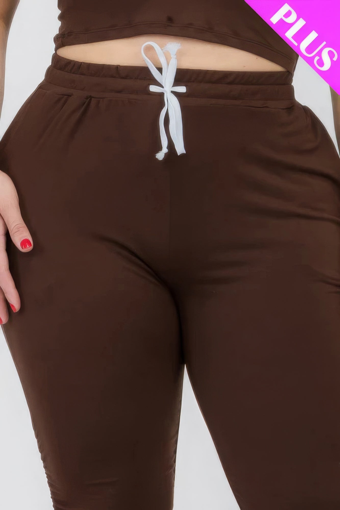 Plus size brown ruched pants with white drawstring, showcasing stretchy and comfortable fit for style and comfort.