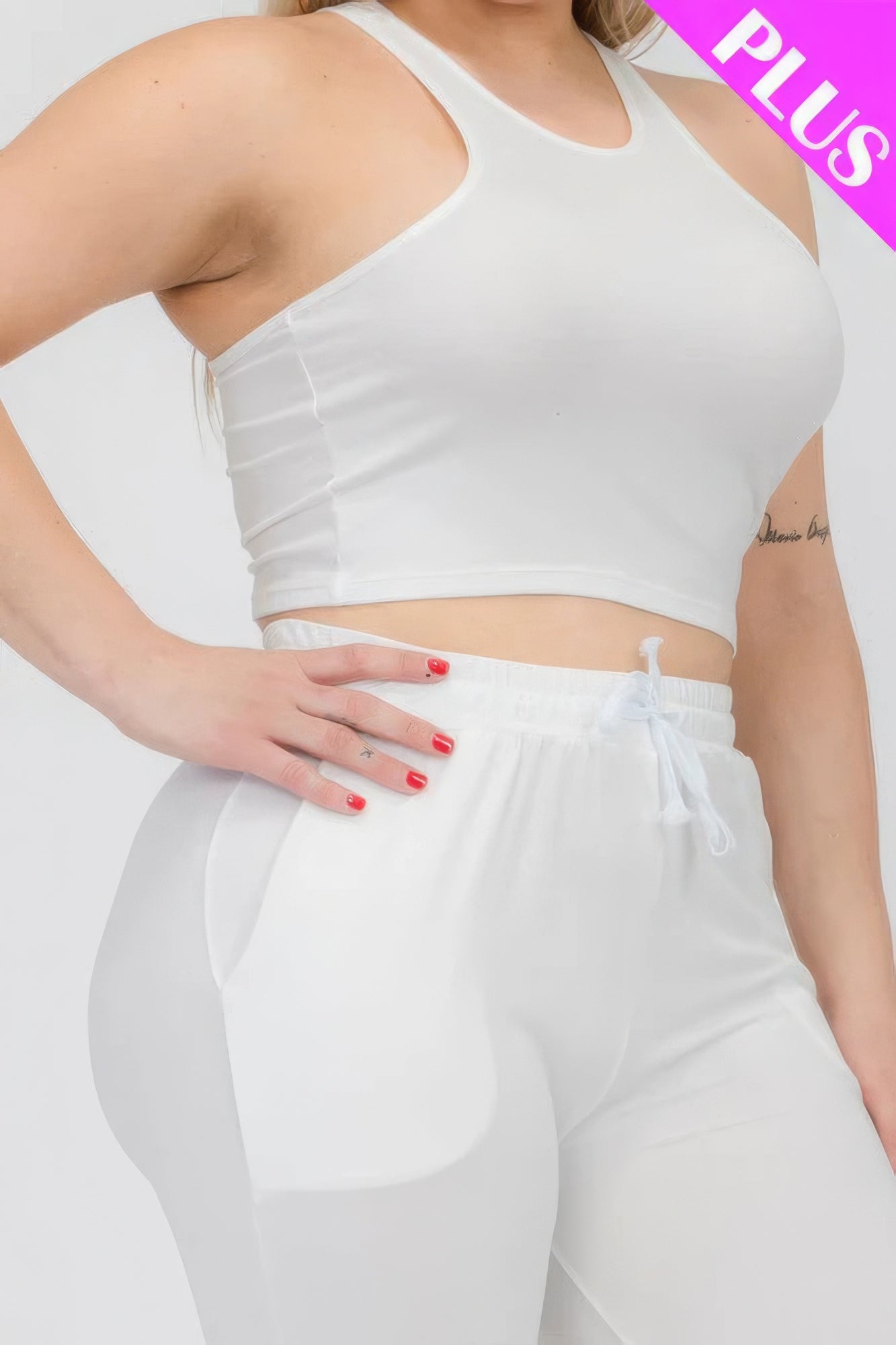 Plus size white crop tank top and ruched pants set showcasing stretchy and comfortable fit.