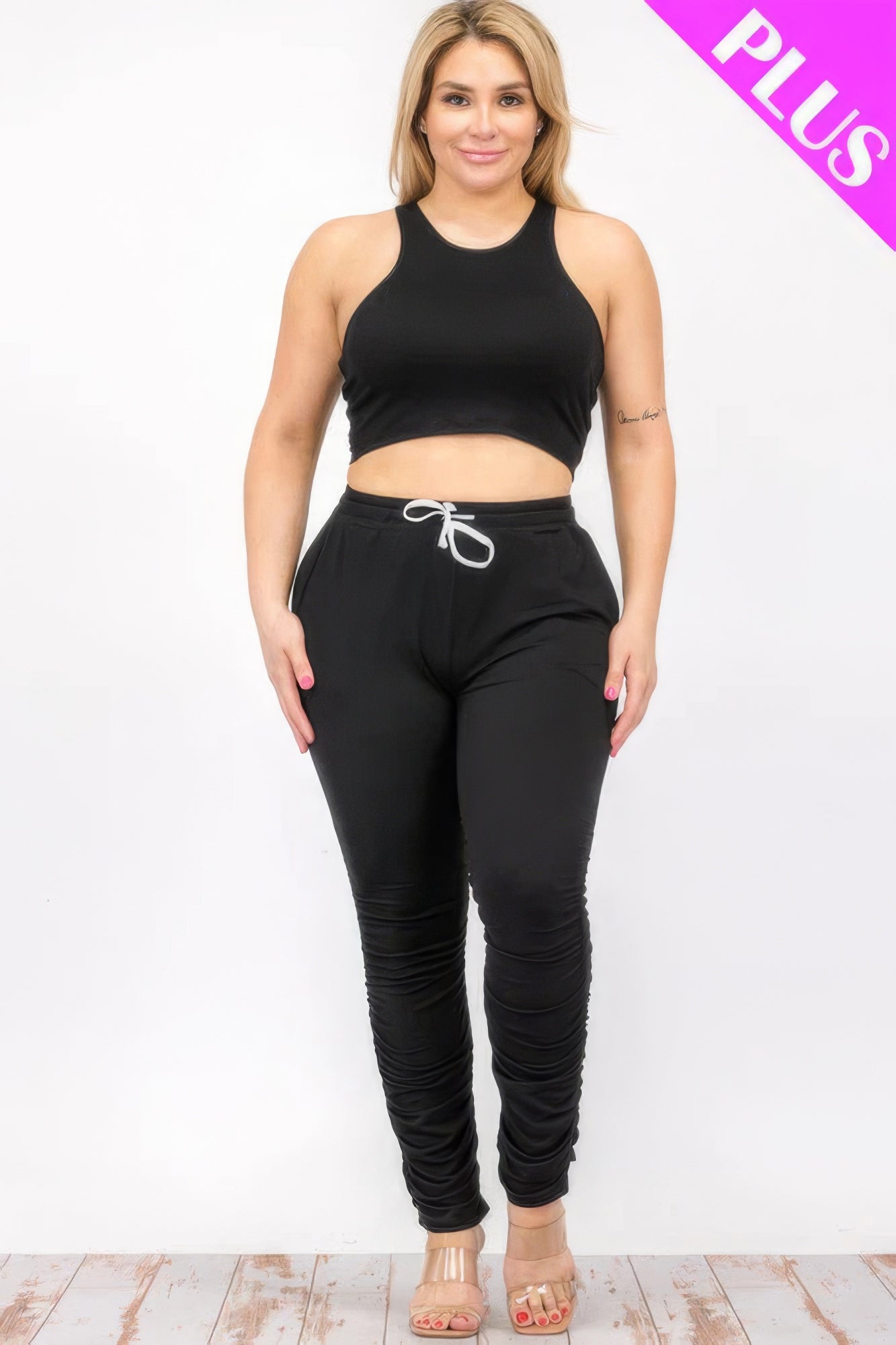 Plus size crop tank top and ruched pants set in black, featuring stretchy polyester-spandex blend for comfort and style.