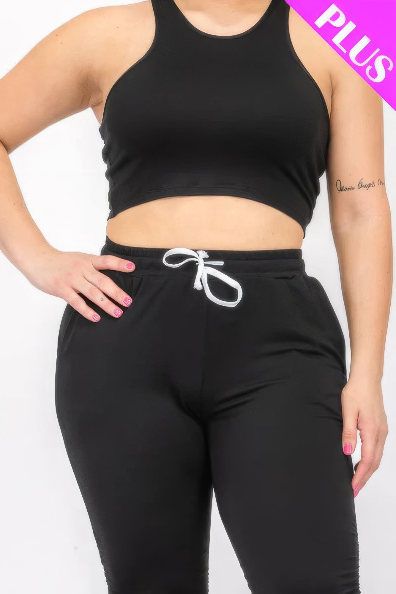 Plus size black crop tank top and ruched pants set with drawstring waist, showcasing comfortable and stylish fit.