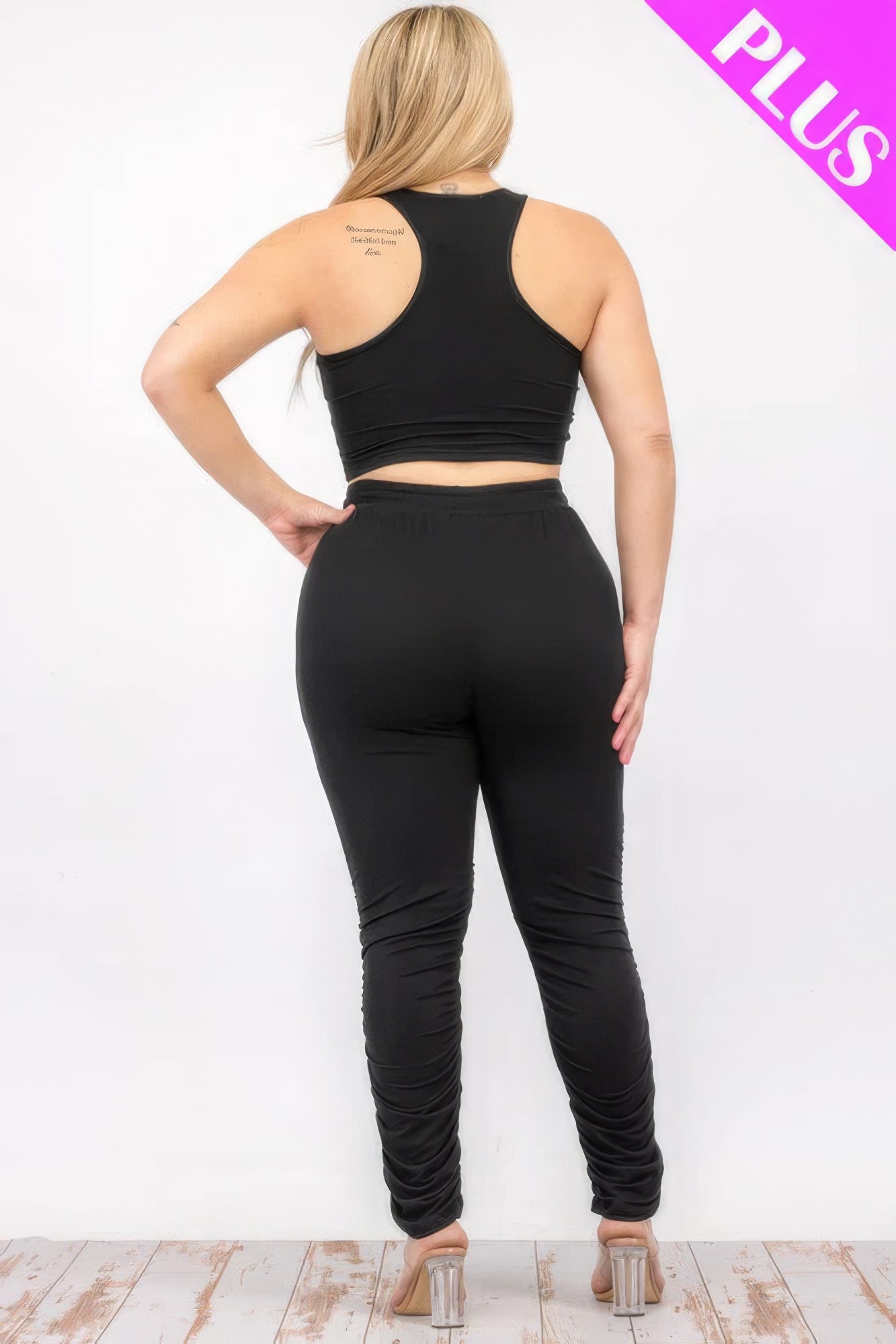 Plus size crop tank top and ruched pants set in black, featuring a back view for style and comfort.