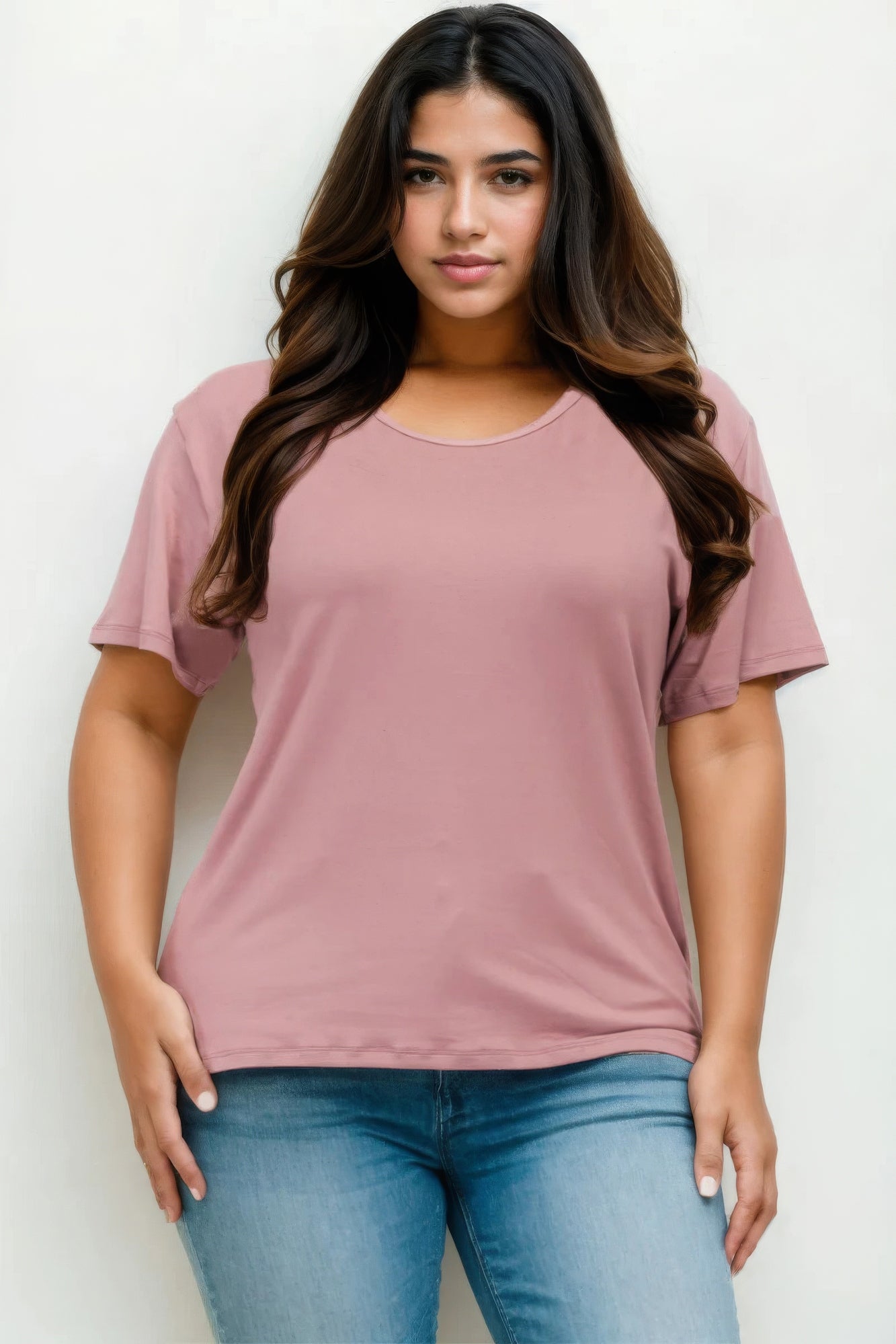 Plus size model wearing a soft pink Basic Short Sleeve T-shirt with relaxed fit from Loveitclothing.com.