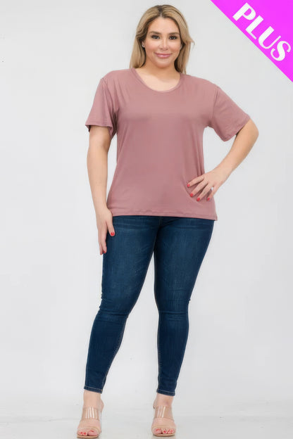 Plus size model wearing a soft pink short sleeve T-shirt paired with blue jeans from Loveitclothing.com, highlighting comfort and style.