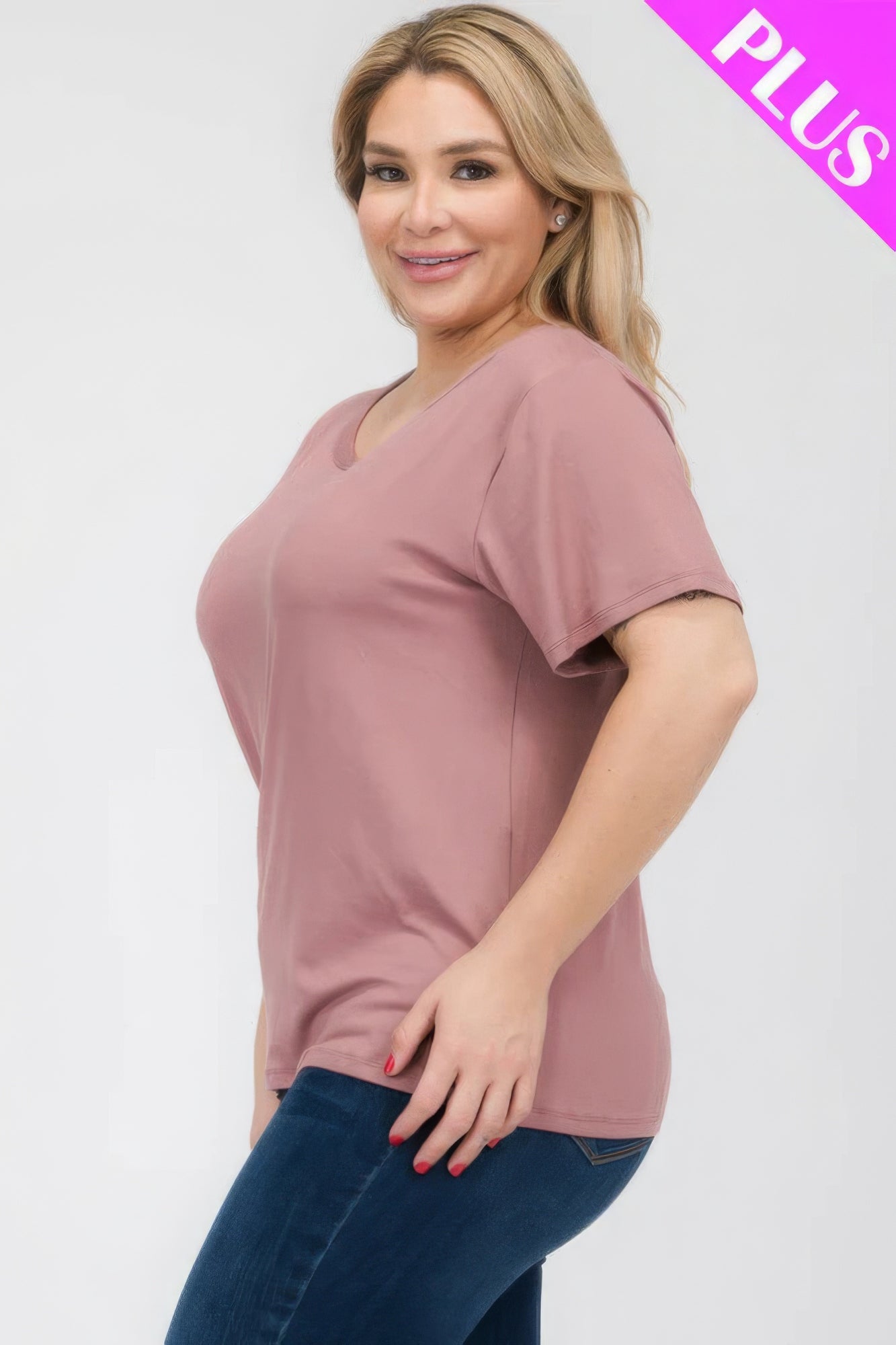 Plus size woman wearing a relaxed fit basic short sleeve T-shirt in blush pink, showcasing comfort and style. Loveitclothing.com.