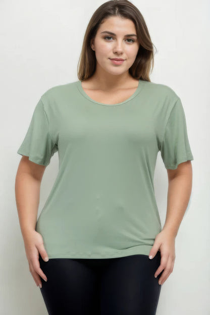 Plus size model wearing a soft green short sleeve t-shirt from Loveitclothing.com, showcasing a relaxed fit and comfort.