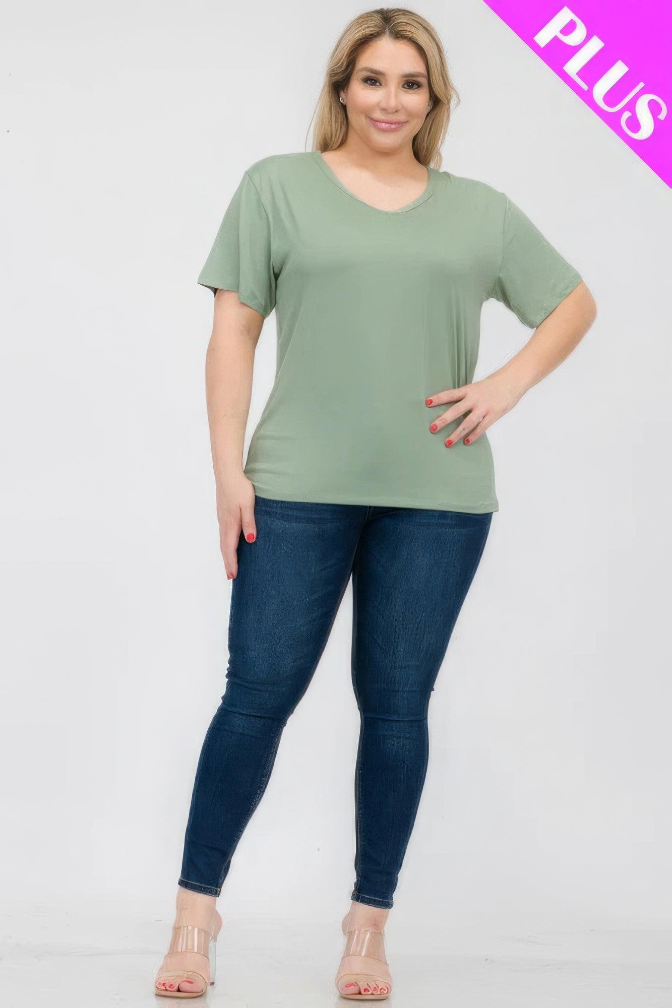 Plus size model wearing a soft green short sleeve t-shirt paired with jeans from Loveitclothing.com.