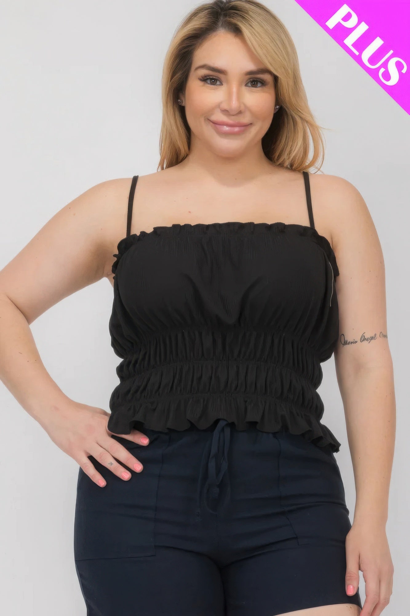 Plus size model wearing black tiered shirred body crop top from Loveitclothing.com.