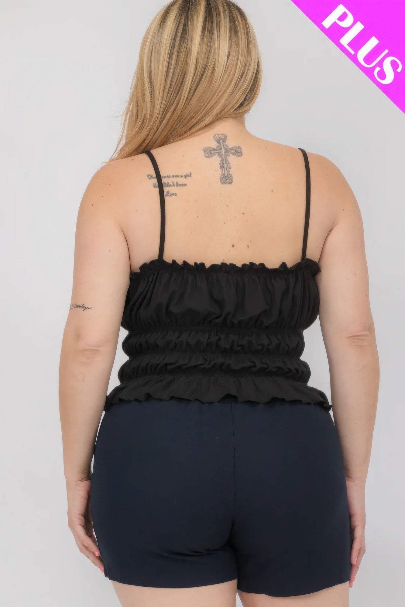 Plus size model wearing black tiered shirred body crop top and shorts from Loveitclothing.com, back view.