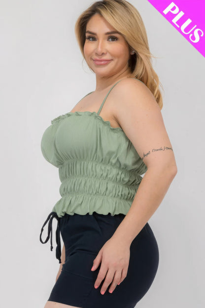 Plus-size woman wearing a green shirred body crop top with black shorts, Loveitclothing.com.