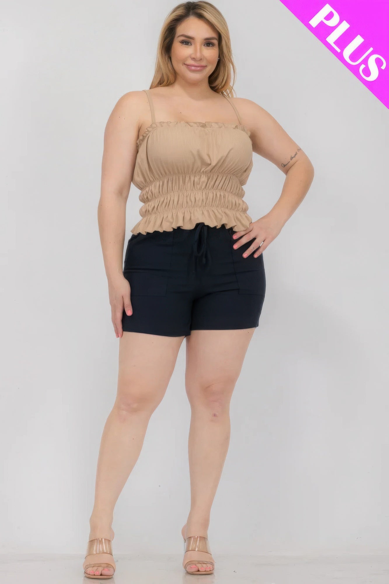 Plus size model wearing a tiered shirred body crop top and shorts from Loveitclothing.com, showcasing a stylish and comfortable fit.