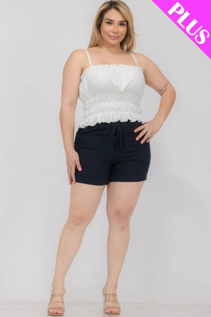 Plus size woman in a white shirred crop top and black shorts with "PLUS" label, from Loveitclothing.com