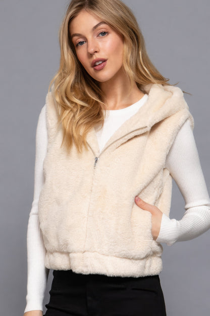 Woman wearing Love It Clothing Vanilla Hoodie Faux Fur Vest, perfect for layering. Relaxed fit, 100% polyester, adds luxury and warmth.