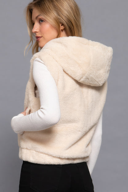 Woman wearing vanilla faux fur hoodie vest from Love It Clothing, showing relaxed fit ideal for layering over tops or sweaters.