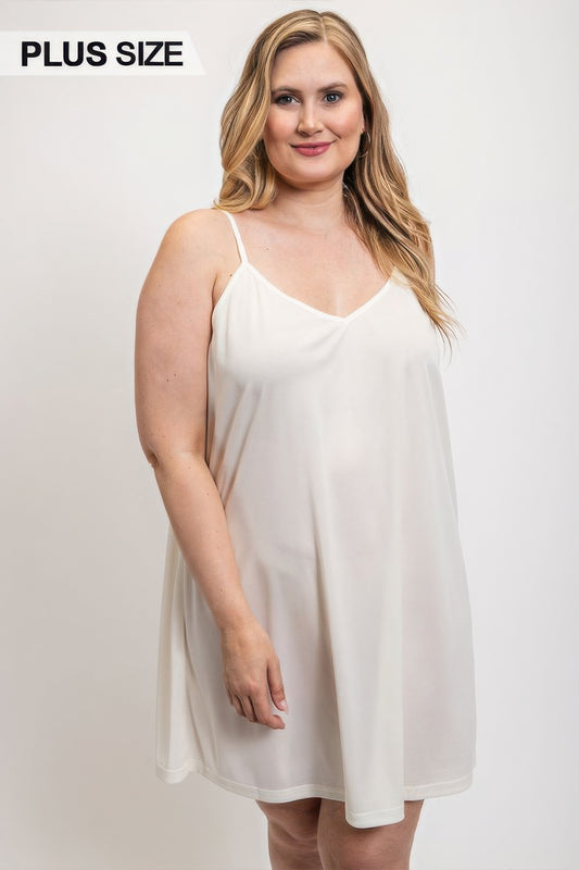 Plus size model wearing white V-neck slip dress with adjustable straps from Loveitclothing.com.