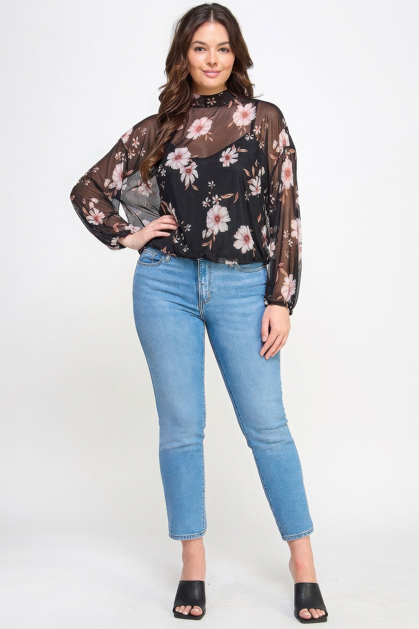 Woman wearing Mesh Floral Long Sleeve Top with Cami from Loveitclothing.com, paired with jeans and heels, showcasing stylish comfort.