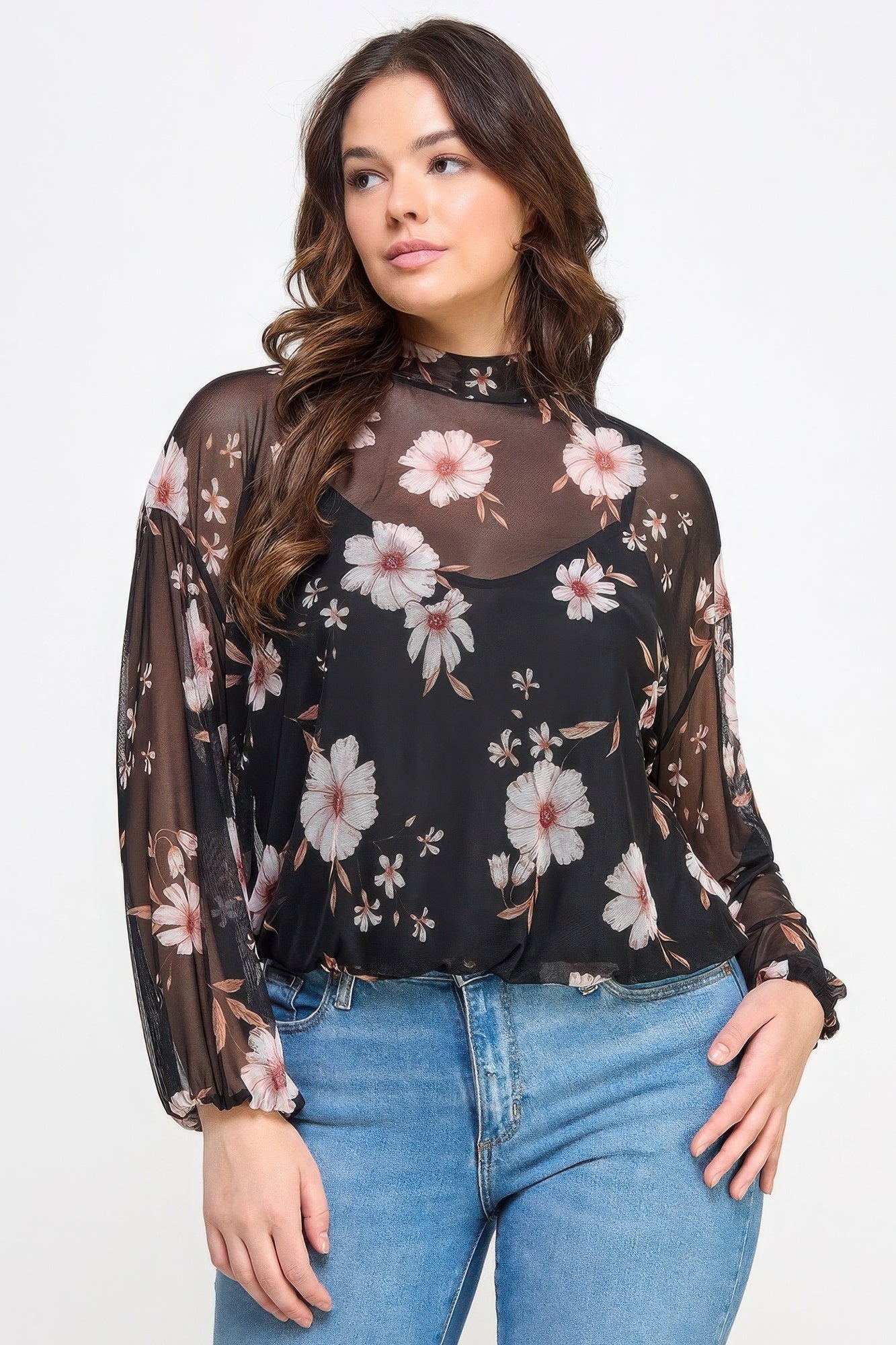 Woman wearing Loveitclothing.com's mesh floral long sleeve top with cami, showcasing style and comfort in lightweight fabric.