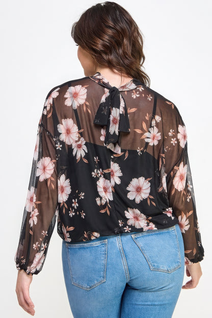 Woman wearing Loveitclothing.com Mesh Floral Long Sleeve Top with Cami, showcasing back floral design.