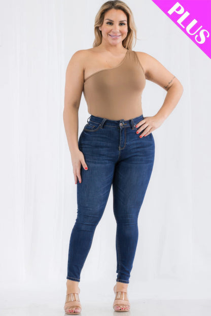 Plus size model wearing a one-shoulder bodysuit styled with high-waisted jeans, showcasing a trendy casual look. Loveitclothing.com.