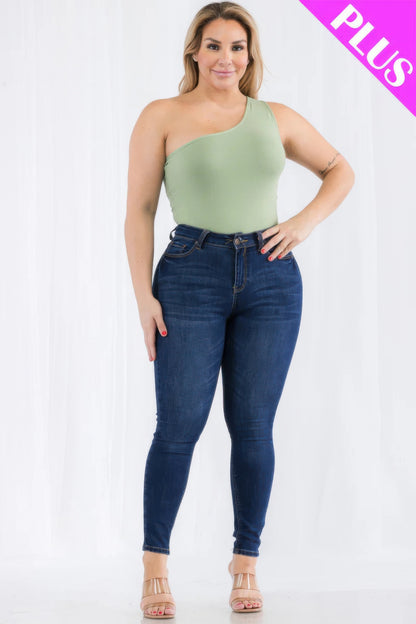 Plus size model wearing a green one shoulder bodysuit with high-waisted jeans, showcasing a chic casual look. Loveitclothing.com.