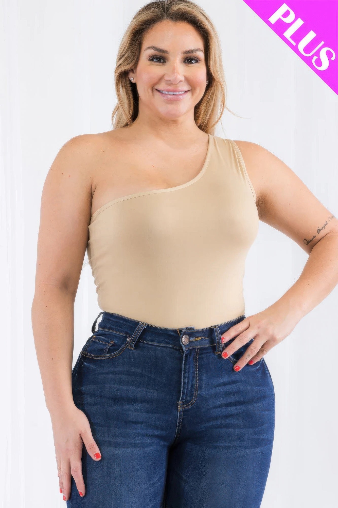 Plus size one shoulder bodysuit in beige, paired with high-waisted jeans for a stylish look at Loveitclothing.com.