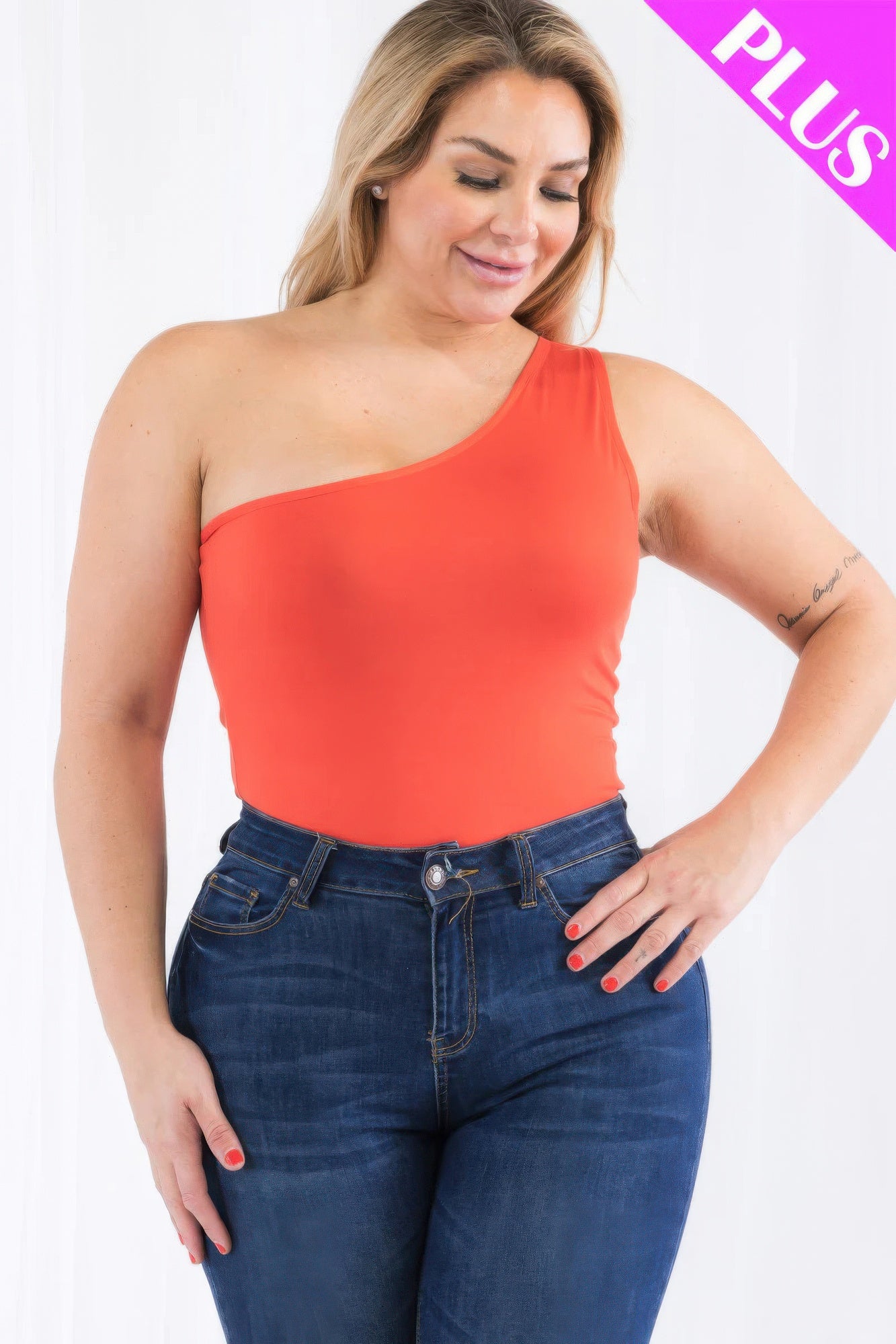 Plus size one shoulder bodysuit in orange worn with high-waisted jeans from Loveitclothing.com.